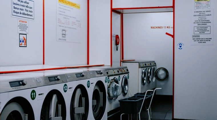 Inside a laundromat with washing machines lined up against the wall